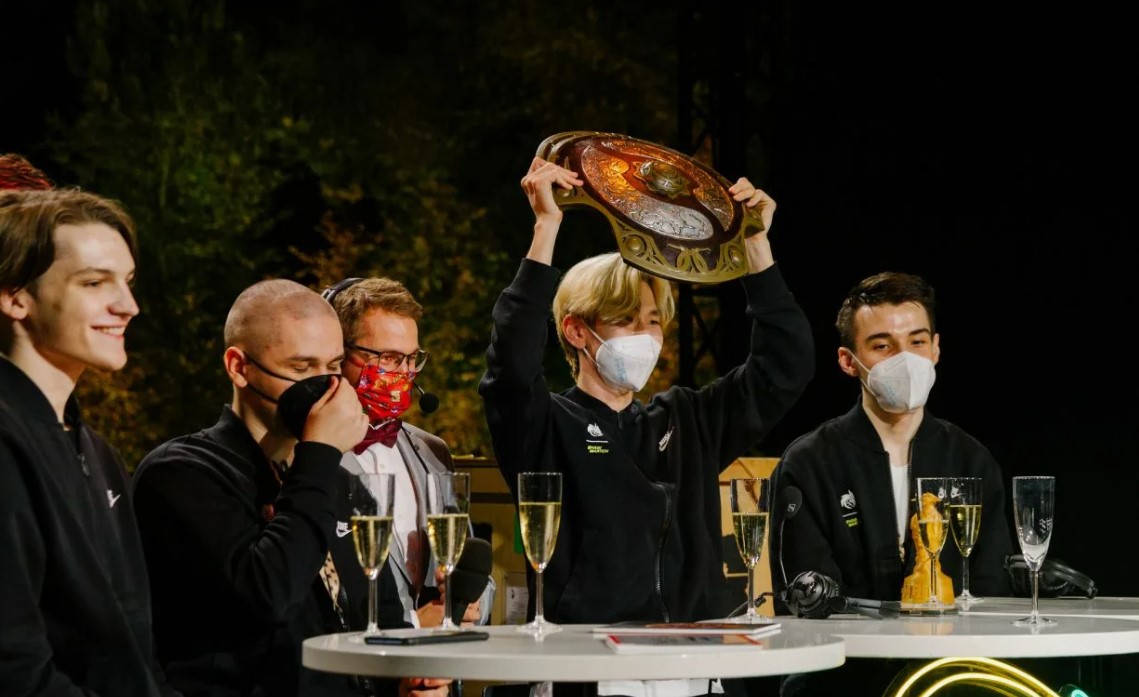 Александр “TORONTOTOKYO” Хертек в числе состава Team Spirit  The International 2021 держит трофей над головой 